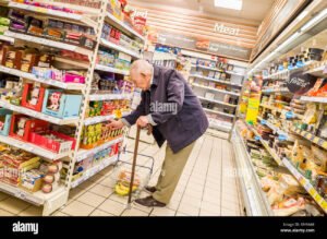 jubilado sonriente comprando en supermercado coto